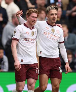 Kevin De Bruyne and Jack Grealish of Manchester City celebrating a goal.