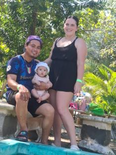 Family with baby by pool.