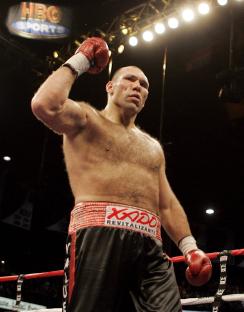 Nikolai Valuev celebrates a victory in a boxing match.