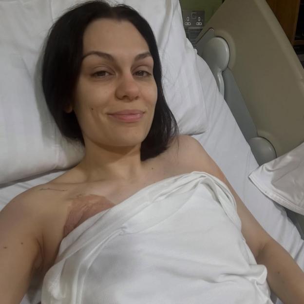 Jessie J in a hospital bed after breast cancer surgery.