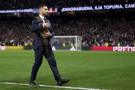 MADRID, SPAIN - FEBRUARY 25: Ilia Topuria UFC featherweight champion salutes the fans prior the game prior the game the LaLiga EA Sports match between Real Madrid CF and Sevilla FC at Estadio Santiago Bernabeu on February 25, 2024 in Madrid, Spain. (Photo by Diego Souto/Getty Images)