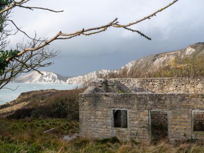 Ruins of a stone building overlooking the sea.