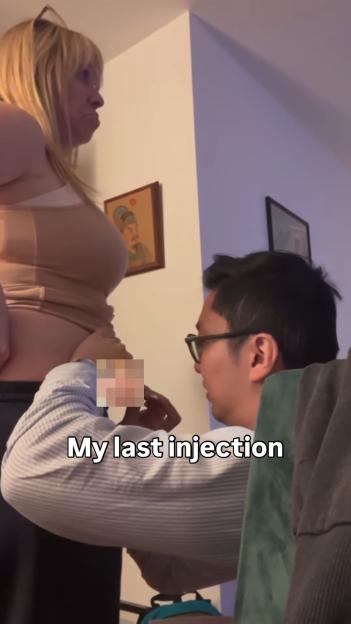 Woman receiving final IVF injection.