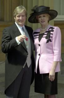 Coronation Street actor William Roache, who plays Ken Barlow in the long running soap, with his wife Sara after he received his Member of the British Empire (MBE) medal from Britain's Queen Elizabeth II at Buckingham Palace in London Tuesday 22 May 2001. See PA story ROYAL Barlow. PA Photo: Matthew Fearn. WPA ROTA