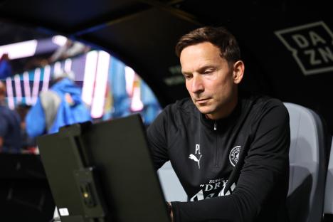 Pepijn Lijnders, assistant manager of Manchester City, looking at a laptop.