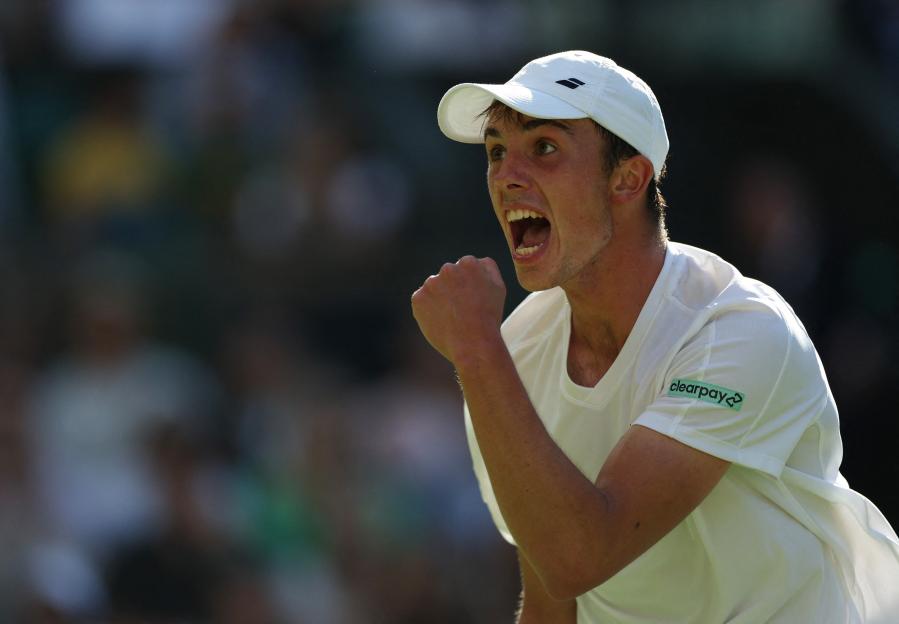 Oliver Tarvet celebrates during a tennis match.