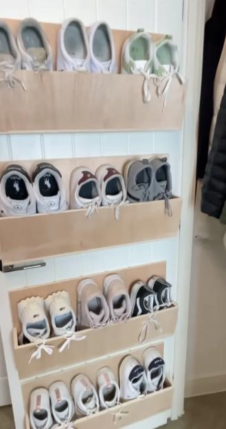 Neatly organized shoes in a door-mounted shelf.