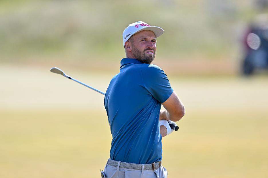 Wyndham Clark taking a golf shot.