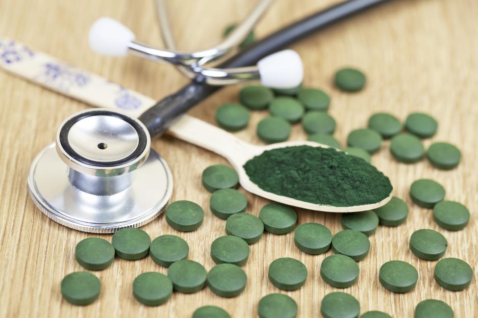 Spirulina powder and pills with a stethoscope.