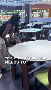 Woman shopping for furniture in a store.