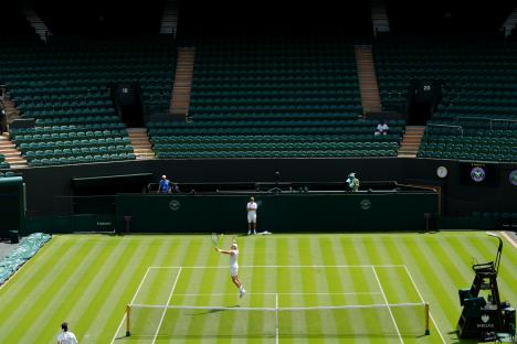 Jack Draper practicing tennis on a court at Wimbledon.