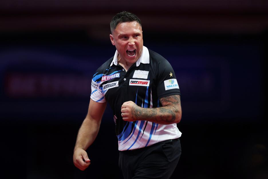 Gerwyn Price of Wales celebrates during a darts match.
