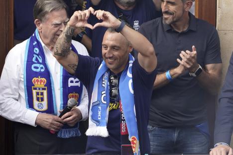Santi Cazorla making a heart shape with his hands while celebrating with fans.