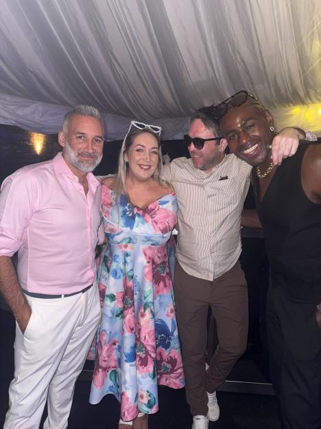Four people posing for a photo.