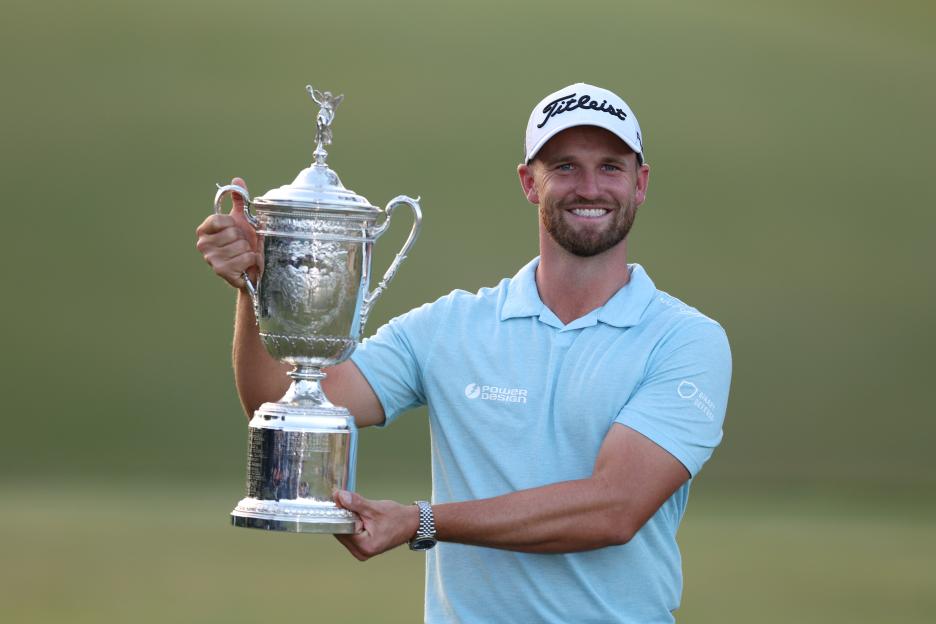 Wyndham Clark holding the U.S. Open Championship trophy.