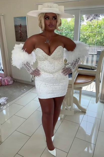 Woman in white feathered bridal-style mini dress and hat.