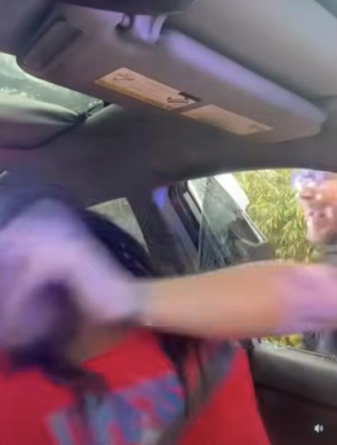 Person being arrested in a car.