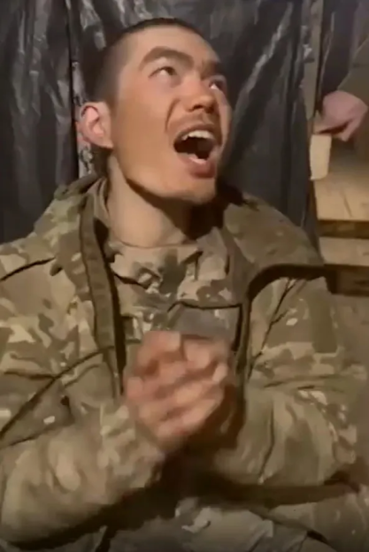 Soldier in camouflage clapping and shouting.