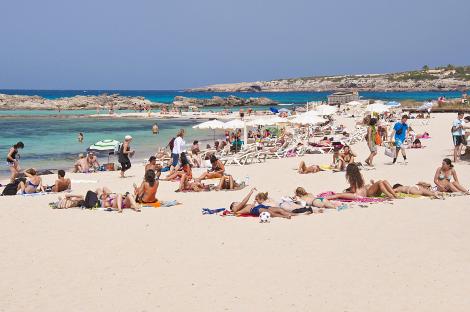 Crowded beach scene in Formentera, Spain.