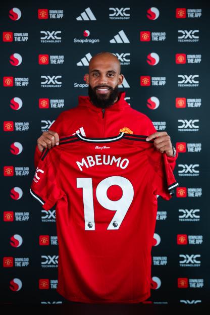 Bryan Mbeumo holding his Manchester United jersey.