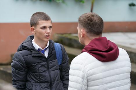 Two young men talking.