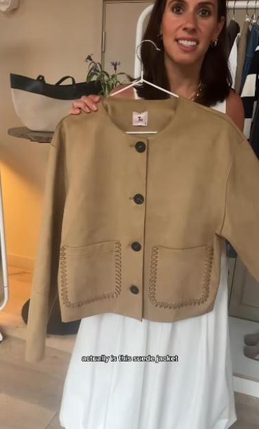 Tan suede jacket on a hanger.