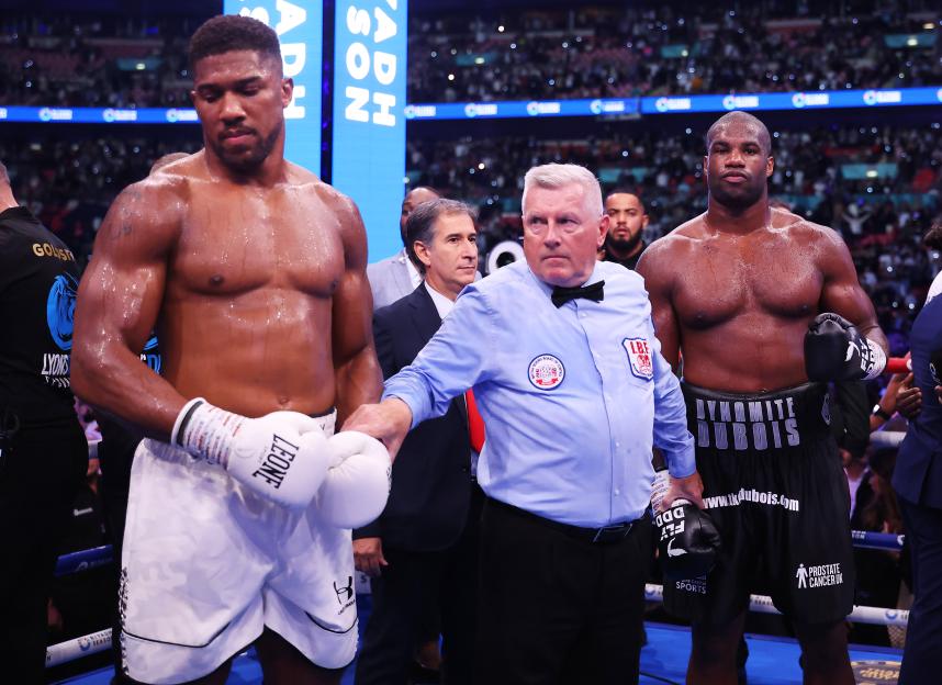 Anthony Joshua and Daniel Dubois with a boxing referee.