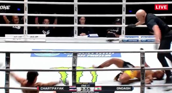 A Muay Thai fighter is knocked down in a ring.