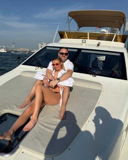 Couple embracing on a yacht.