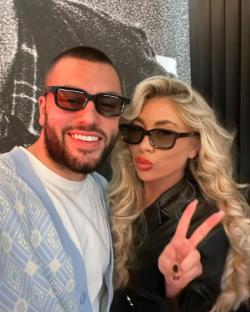 a man and a woman wearing sunglasses pose for a picture