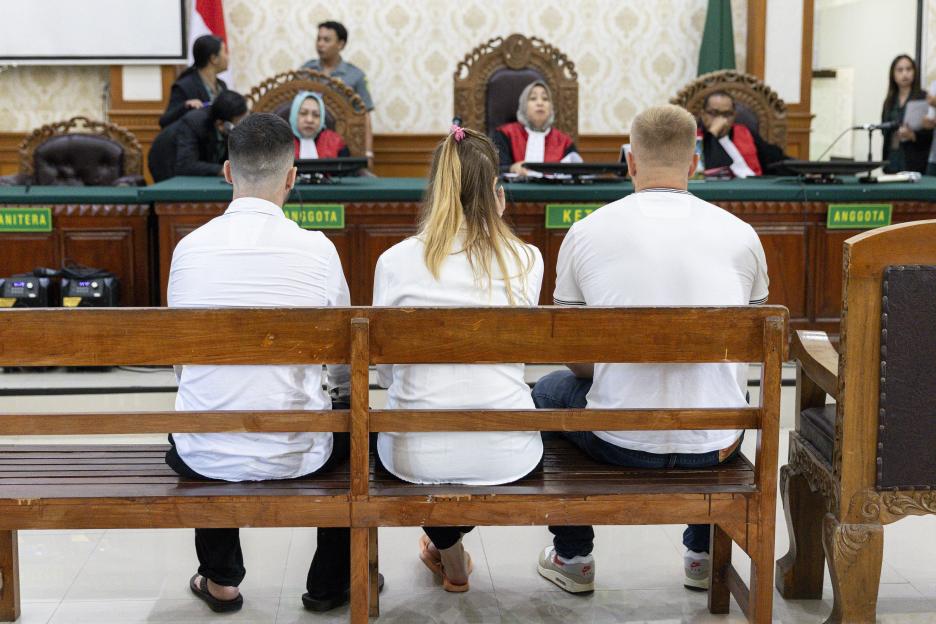 Three British nationals sit in court during a drug smuggling trial in Bali, Indonesia.