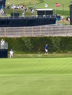 Golfer putting on green at Oakmont.
