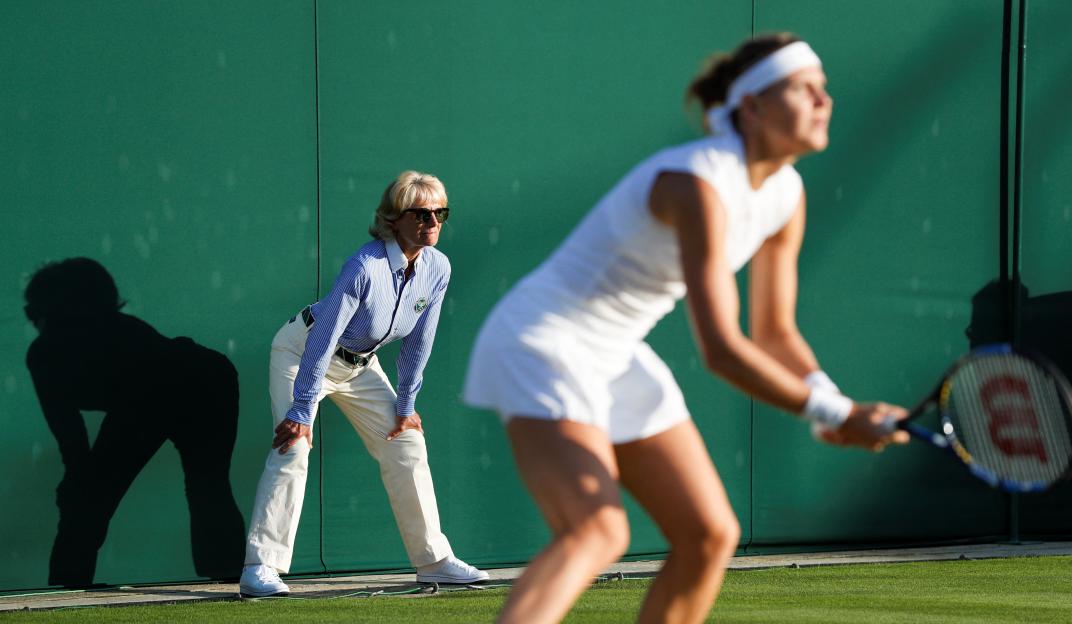 A line judge watches a tennis match.