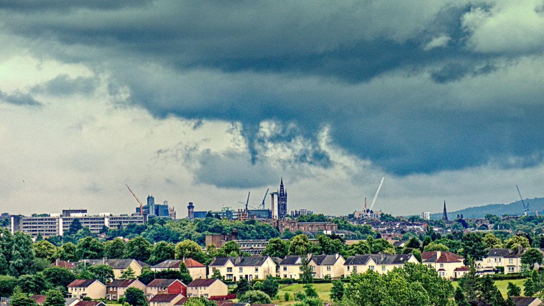 Glasgow, Scotland under a stormy sky.