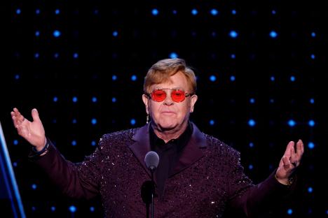 Elton John presenting an award.