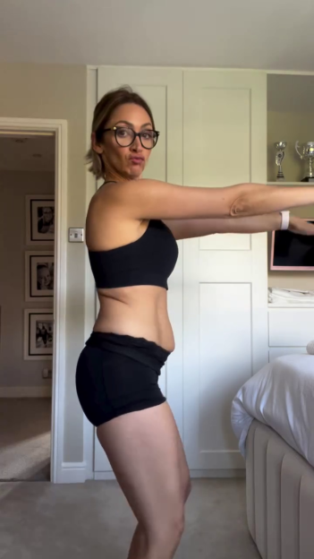 Woman in workout clothes showing her body.