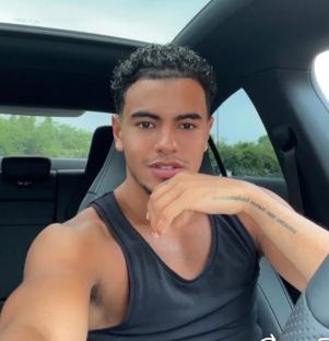 Man sitting in a car, looking at the camera.