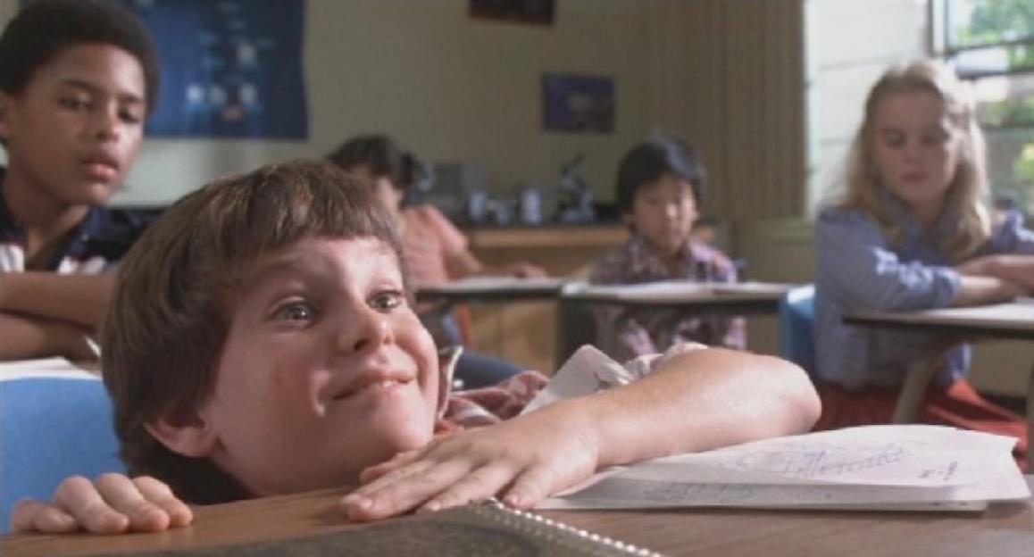 Elliot from E.T. appearing intoxicated in a classroom.