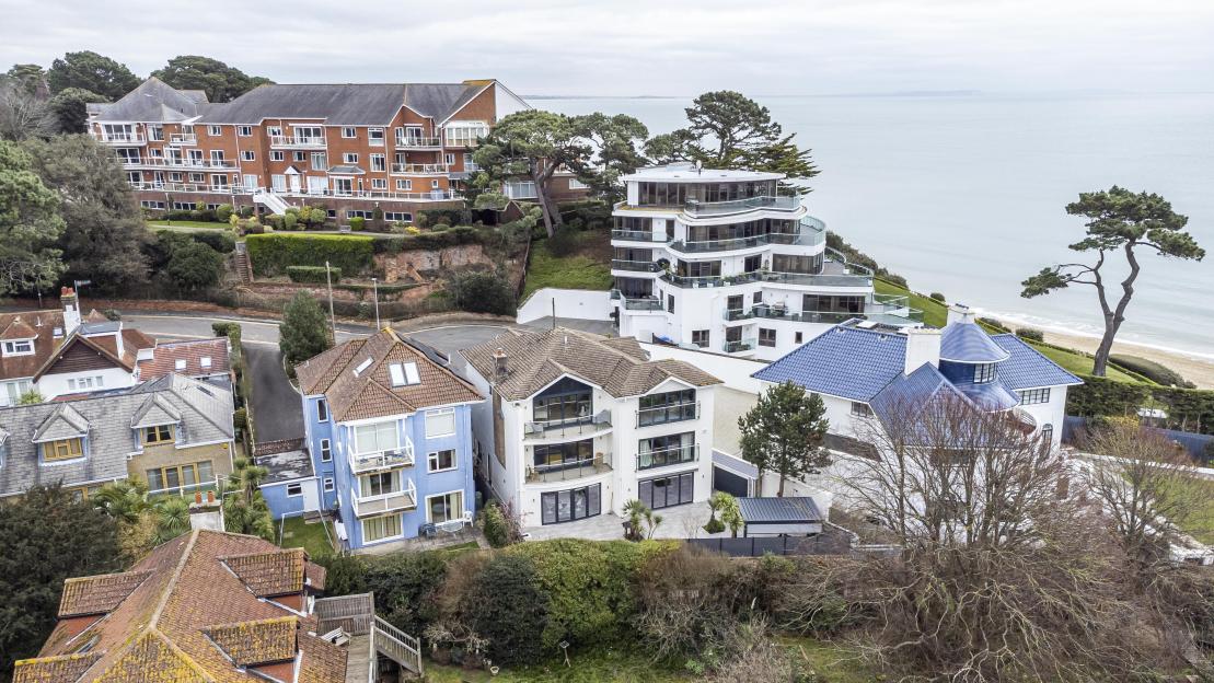 Aerial view of houses near the ocean.
