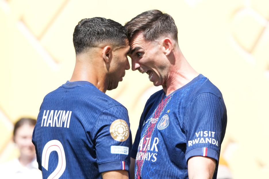 Two Paris Saint-Germain soccer players face each other.
