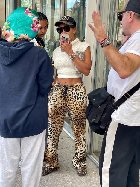 Mel B wearing leopard print pants and sunglasses outside a hotel.