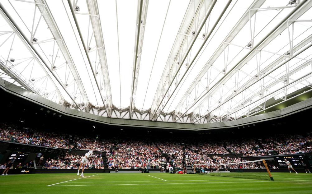 Jannik Sinner playing tennis at Wimbledon.