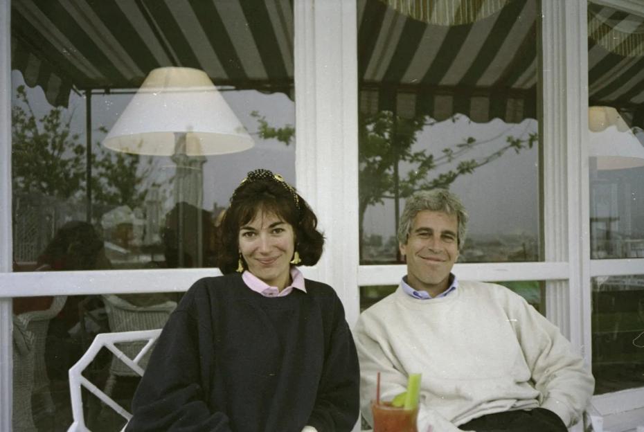 a man and a woman sit next to each other in front of a window