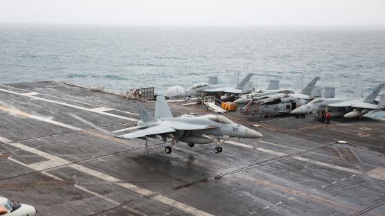 F/A-18E Super Hornet landing on aircraft carrier.