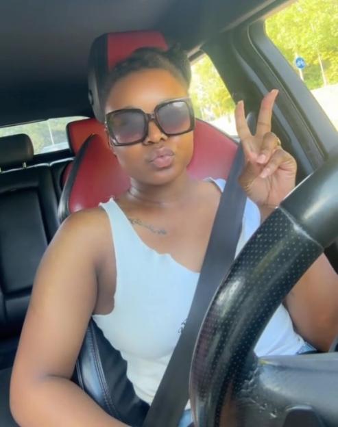 Woman in a car making a peace sign, celebrating 3k followers.