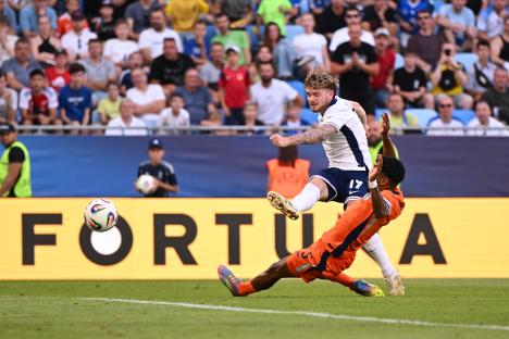 Harvey Elliott of England scores a goal during a soccer match.