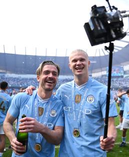 Jack Grealish and Erling Haaland of Manchester City celebrate their Premier League victory.