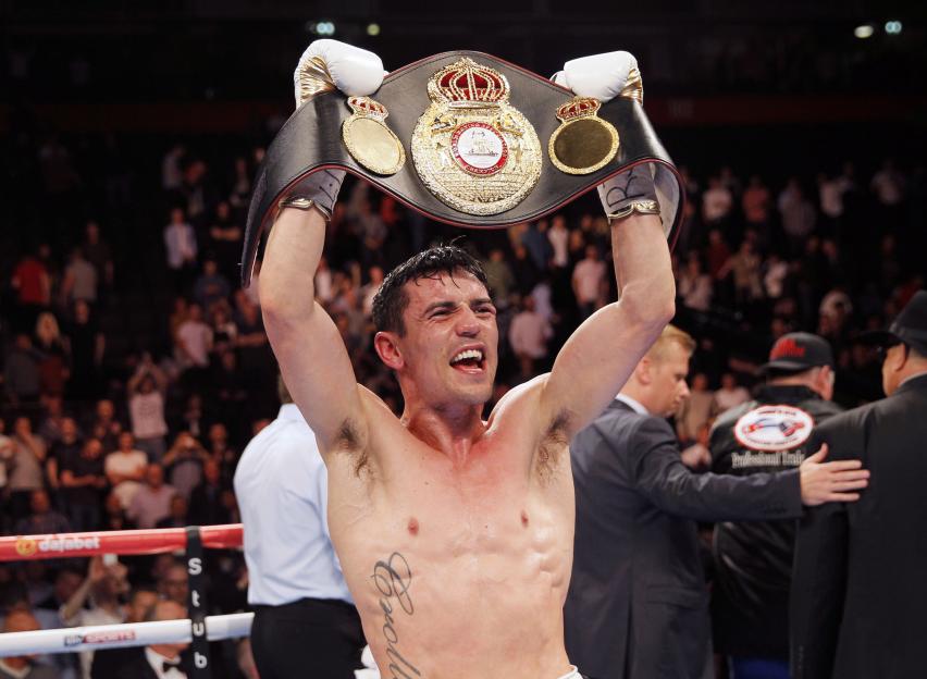Anthony Crolla holding up a boxing championship belt.