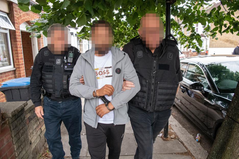 Immigration officers arresting a man suspected of people smuggling.