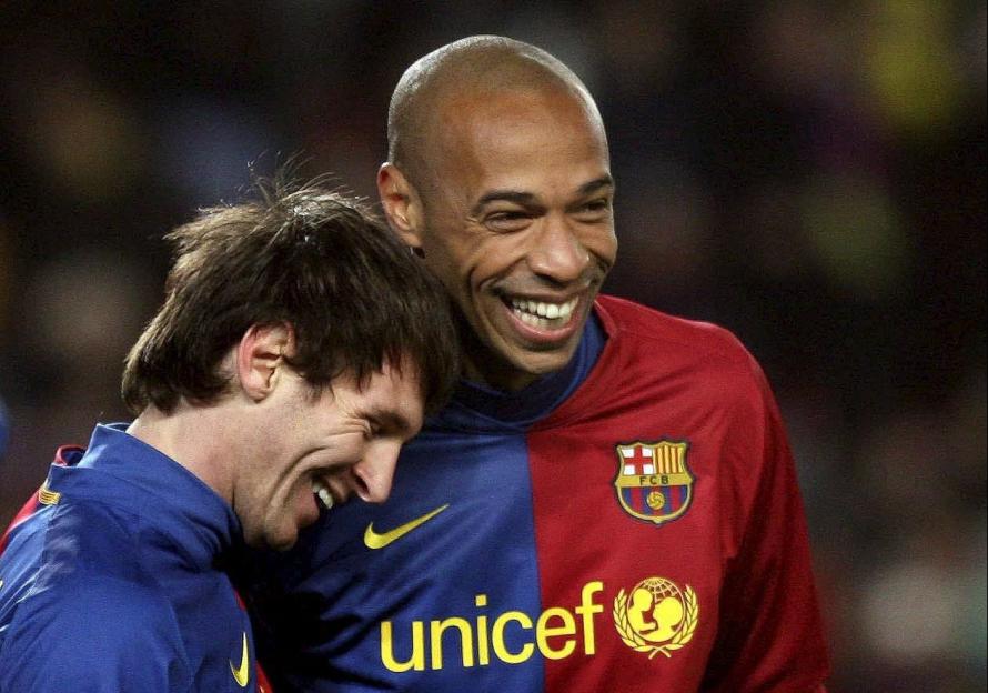 Lionel Messi and Thierry Henry celebrating after a Barcelona soccer match.